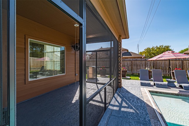 view of patio featuring fence and a fenced in pool