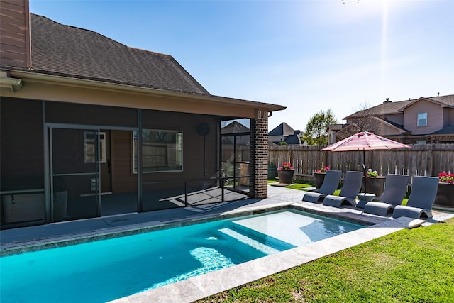 view of pool with a patio area, fence, a fenced in pool, and a sunroom