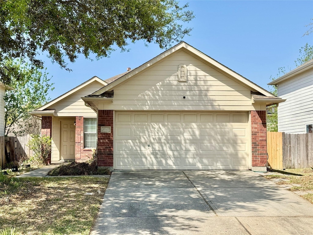 20107 Southern Leaf Ln, Humble, TX 77338 - single story home featuring concrete driveway, a garage, fence, and brick siding