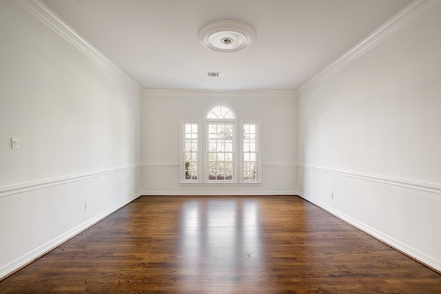 spare room with crown molding, baseboards, dark wood-style floors, and visible vents