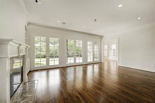 unfurnished living room featuring ornamental molding, recessed lighting, a fireplace, dark wood-type flooring, and visible vents