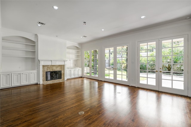 unfurnished living room with french doors, recessed lighting, visible vents, and a fireplace