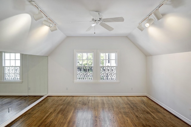 additional living space featuring a healthy amount of sunlight, wood finished floors, and baseboards