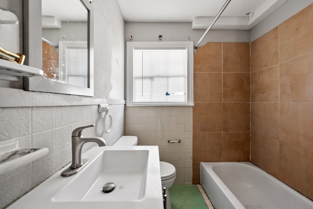 1017 Canadian St, Houston, TX 77009 - bathroom with bathtub / shower combination, tile walls, toilet, and a sink