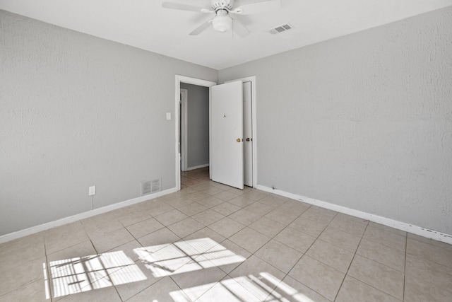 1017 Canadian St, Houston, TX 77009 - unfurnished room featuring visible vents, baseboards, light tile patterned flooring, and a ceiling fan