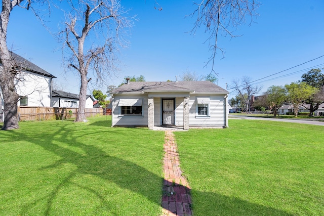 1017 Canadian St, Houston, TX 77009 - back of property with fence, a lawn, and roof with shingles