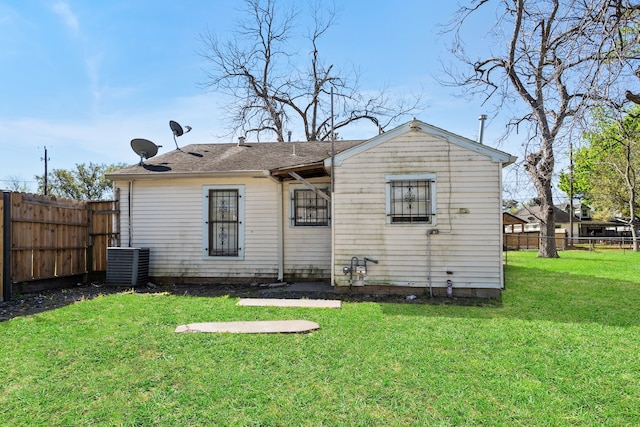 1017 Canadian St, Houston, TX 77009 - back of property with cooling unit, a lawn, and a fenced backyard