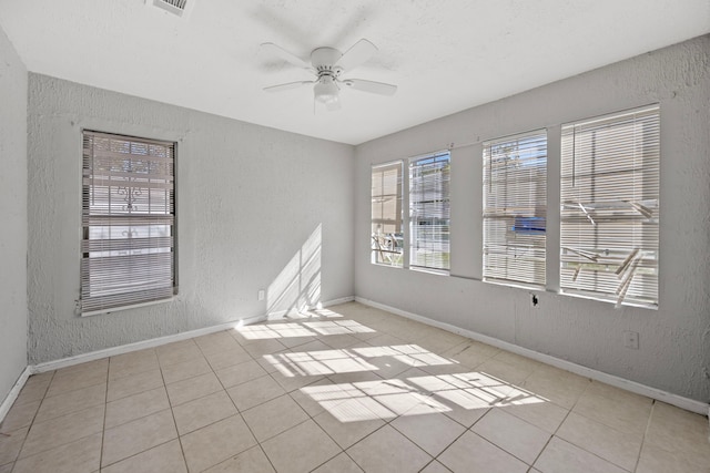 1017 Canadian St, Houston, TX 77009 - tiled spare room with a ceiling fan, a textured wall, and baseboards
