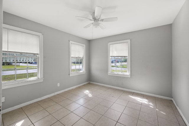 1017 Canadian St, Houston, TX 77009 - empty room with light tile patterned floors, baseboards, and a ceiling fan