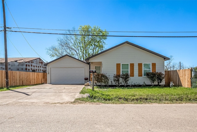 single story home featuring concrete driveway, an attached garage, and fence
