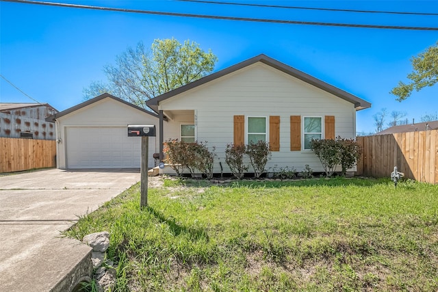 view of front facade with fence, a front lawn, concrete driveway, and an attached garage