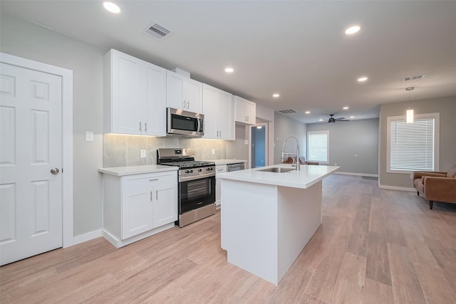 kitchen featuring open floor plan, a sink, stainless steel appliances, and visible vents