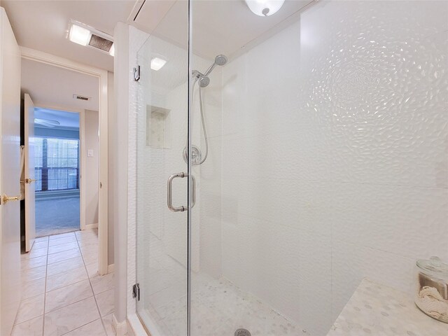full bath featuring a shower stall and tile patterned flooring