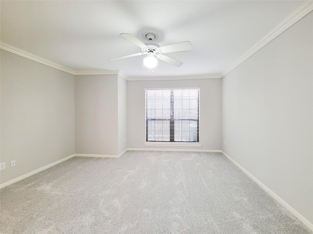 unfurnished room featuring carpet floors, ornamental molding, and a ceiling fan