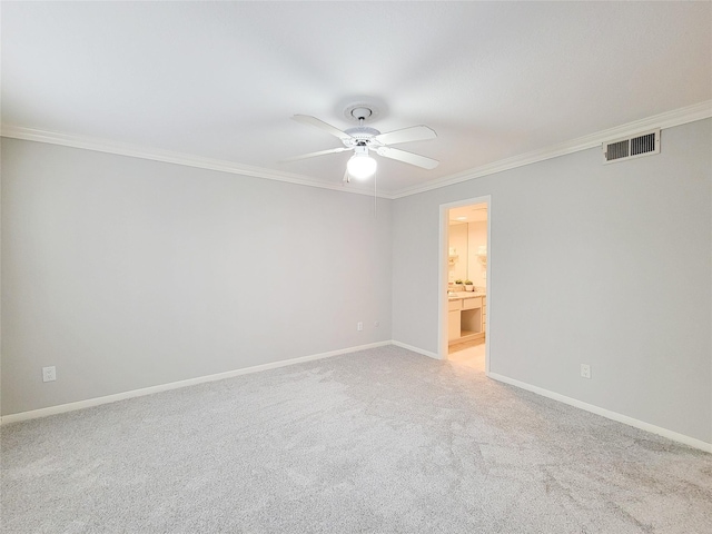 empty room featuring crown molding, a ceiling fan, light carpet, baseboards, and visible vents