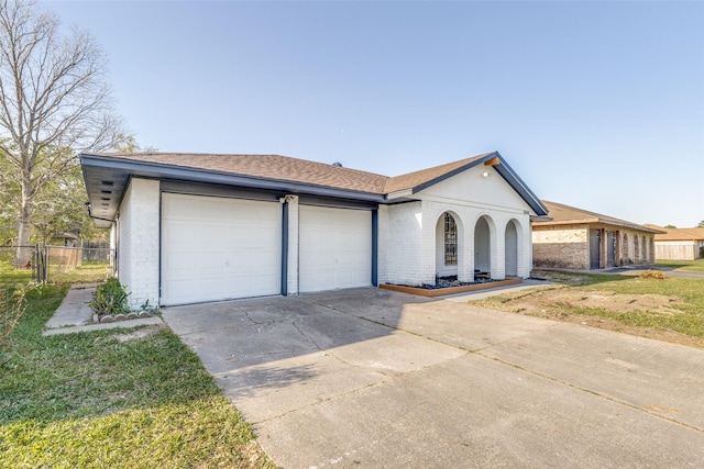 single story home with brick siding, a garage, fence, and concrete driveway