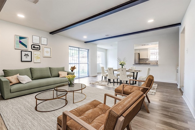 living area featuring baseboards, recessed lighting, and wood finished floors