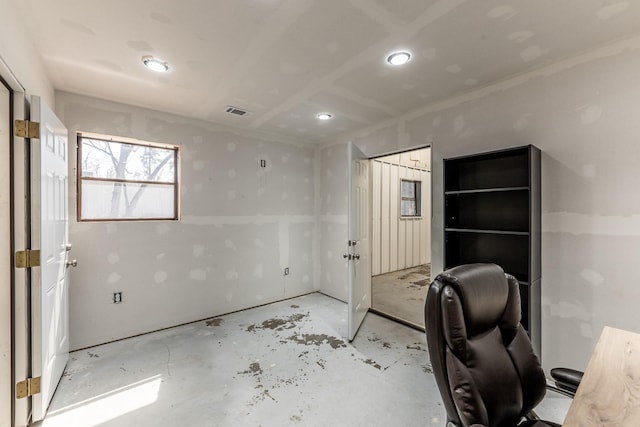 407 S Home St, Corrigan, TX 75939 - unfurnished office featuring visible vents and unfinished concrete flooring