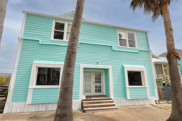 2025 Avenue N 1/2 Ave N 1/2, Galveston, TX 77550 - view of front facade featuring french doors and entry steps