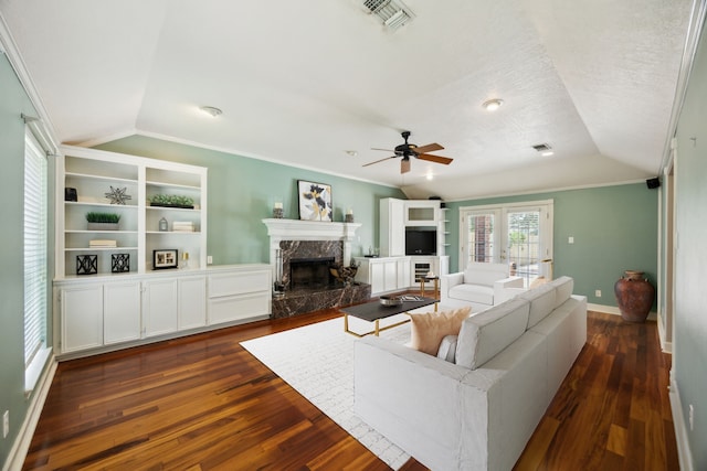 17207 Penick Rd, Waller, TX 77484 - living room with vaulted ceiling, ceiling fan, a fireplace, dark wood-type flooring, and baseboards
