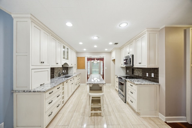 17207 Penick Rd, Waller, TX 77484 - kitchen featuring stainless steel appliances, baseboards, backsplash, light stone counters, and recessed lighting