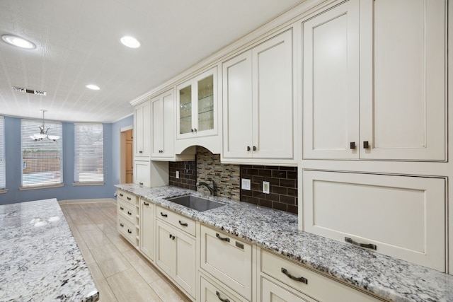 17207 Penick Rd, Waller, TX 77484 - kitchen featuring a sink, baseboards, recessed lighting, a chandelier, and light tile patterned floors