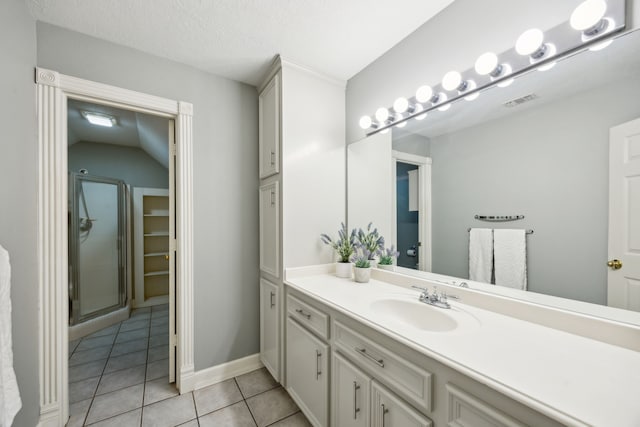 17207 Penick Rd, Waller, TX 77484 - bathroom with vanity, tile patterned flooring, a shower with door, and baseboards