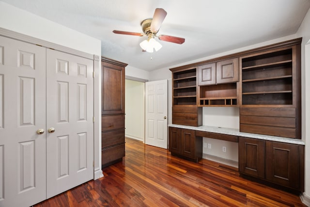17207 Penick Rd, Waller, TX 77484 - unfurnished office with built in study area, dark wood finished floors, a ceiling fan, and baseboards