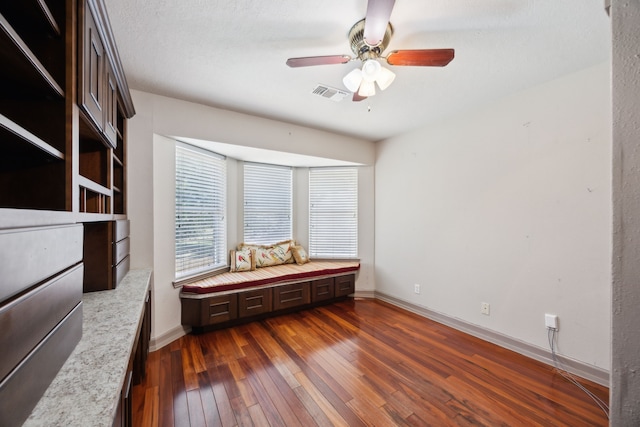 17207 Penick Rd, Waller, TX 77484 - spare room featuring dark wood finished floors, a ceiling fan, and baseboards