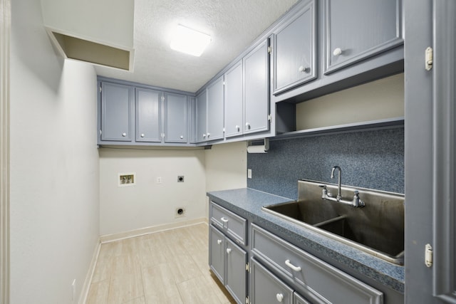 17207 Penick Rd, Waller, TX 77484 - laundry room with hookup for an electric dryer, washer hookup, baseboards, cabinet space, and a textured ceiling