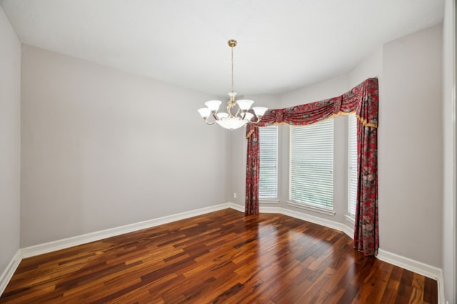 17207 Penick Rd, Waller, TX 77484 - unfurnished room with wood finished floors, baseboards, and a chandelier