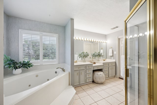 17207 Penick Rd, Waller, TX 77484 - bathroom featuring double vanity, a tub with jets, a stall shower, wallpapered walls, and tile patterned flooring