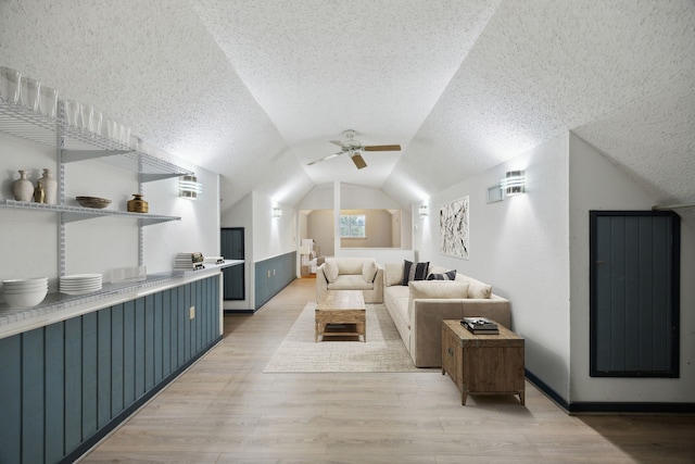 17207 Penick Rd, Waller, TX 77484 - living area featuring lofted ceiling, a textured ceiling, light wood-style flooring, and ceiling fan