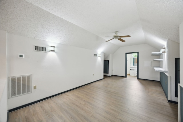 17207 Penick Rd, Waller, TX 77484 - additional living space with a textured ceiling, lofted ceiling, wood finished floors, ceiling fan, and baseboards