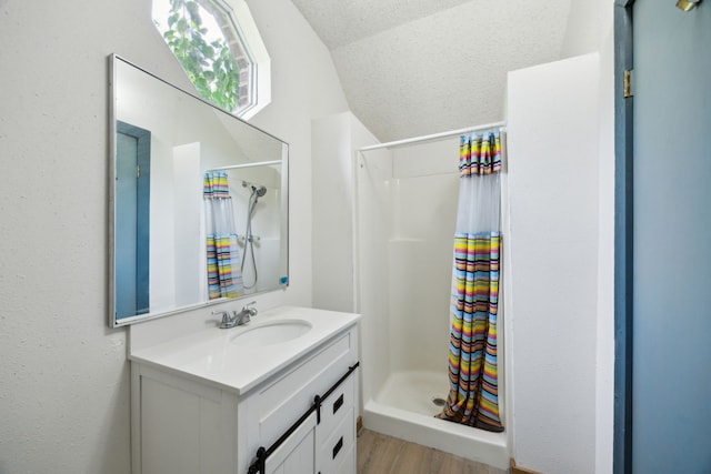 17207 Penick Rd, Waller, TX 77484 - bathroom with a shower stall, lofted ceiling, vanity, and wood finished floors