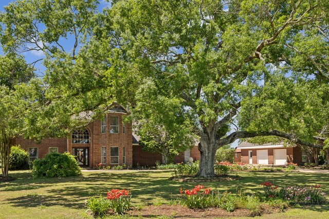 17207 Penick Rd, Waller, TX 77484 - view of front of home featuring brick siding and a front lawn