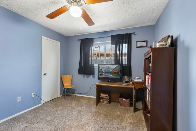carpeted home office with a ceiling fan, baseboards, and a textured ceiling