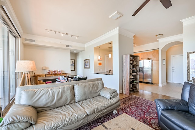 3333 Allen Pkwy Unit 1804, Houston, TX 77019 - living room featuring ceiling fan, track lighting, arched walkways, ornamental molding, and light wood finished floors