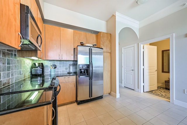 3333 Allen Pkwy Unit 1804, Houston, TX 77019 - kitchen featuring stainless steel appliances, dark countertops, backsplash, light tile patterned floors, and crown molding