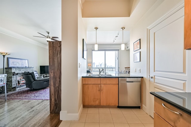 3333 Allen Pkwy Unit 1804, Houston, TX 77019 - kitchen featuring stainless steel dishwasher, dark countertops, baseboards, a sink, and a ceiling fan