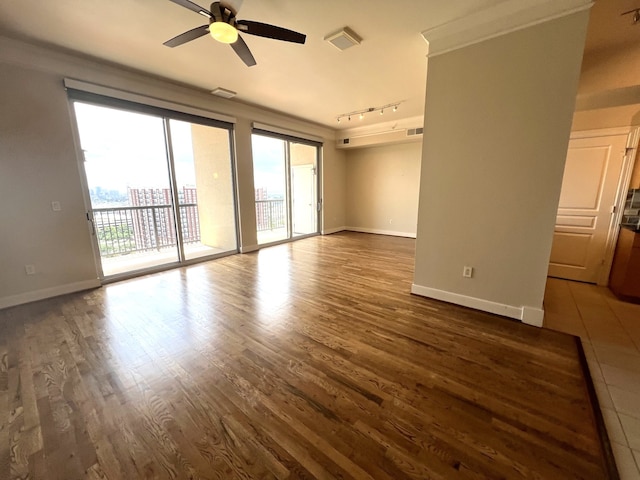 3333 Allen Pkwy Unit 1804, Houston, TX 77019 - empty room with rail lighting, ceiling fan, and dark wood-type flooring
