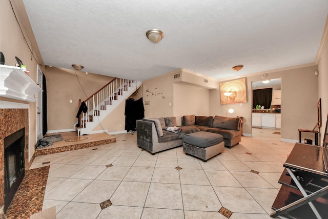 12041 Willow Trl, Houston, TX 77035 - living area featuring stairway, light tile patterned floors, a fireplace, and ornamental molding