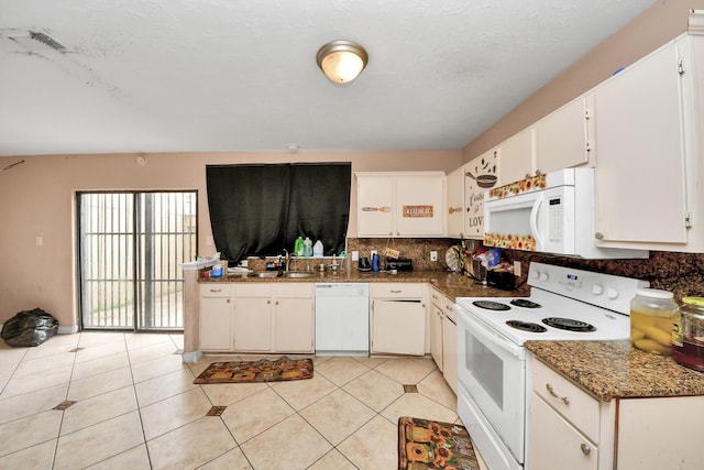 12041 Willow Trl, Houston, TX 77035 - kitchen with white appliances, tasteful backsplash, white cabinets, and light tile patterned floors