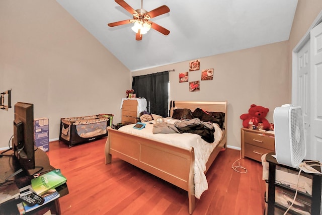 bedroom featuring ceiling fan, baseboards, lofted ceiling, and wood finished floors