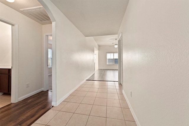 6906 Chessgate Falls Ln, Rosenberg, TX 77469 - corridor with light tile patterned floors, arched walkways, baseboards, and visible vents