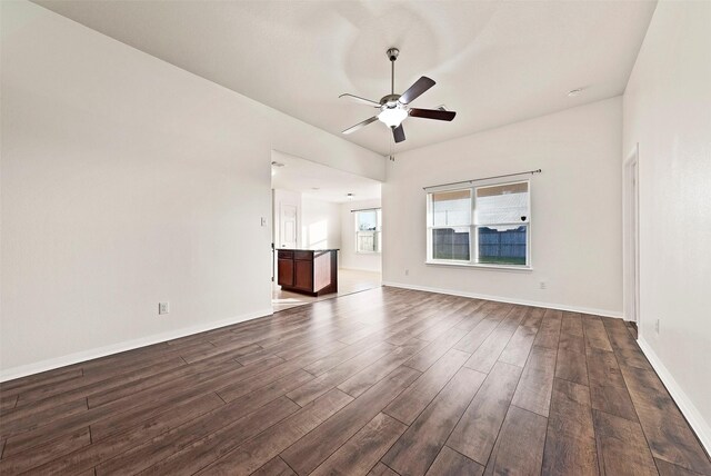 6906 Chessgate Falls Ln, Rosenberg, TX 77469 - unfurnished room with baseboards, ceiling fan, and dark wood-style flooring