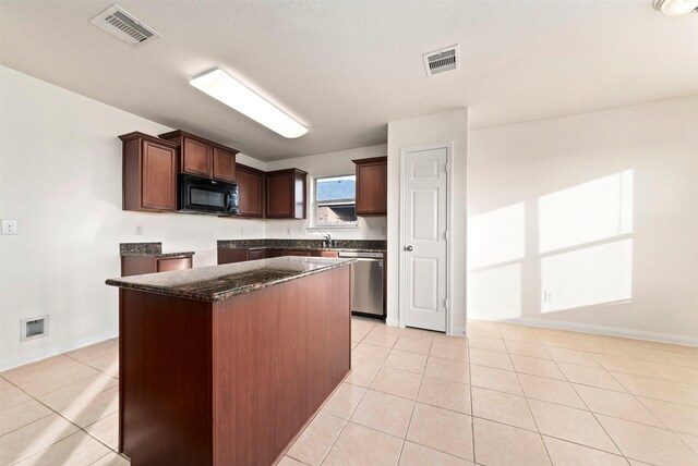 6906 Chessgate Falls Ln, Rosenberg, TX 77469 - kitchen featuring light tile patterned flooring, visible vents, dishwasher, black microwave, and a center island