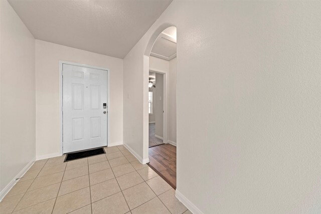 6906 Chessgate Falls Ln, Rosenberg, TX 77469 - entryway with arched walkways, baseboards, and light tile patterned flooring