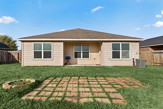 6906 Chessgate Falls Ln, Rosenberg, TX 77469 - back of house with cooling unit, a fenced backyard, a patio, and a lawn