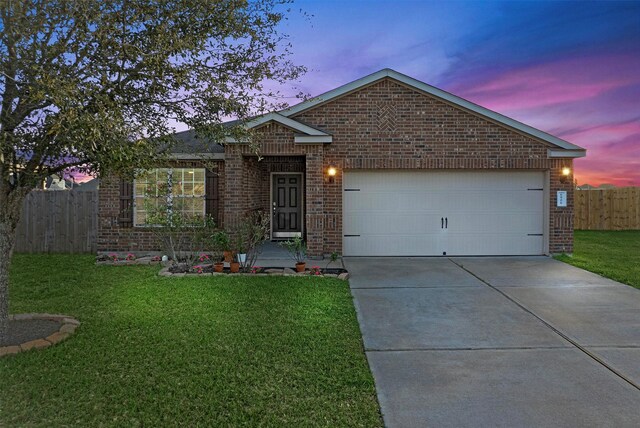6906 Chessgate Falls Ln, Rosenberg, TX 77469 - ranch-style home featuring driveway, fence, an attached garage, brick siding, and a lawn